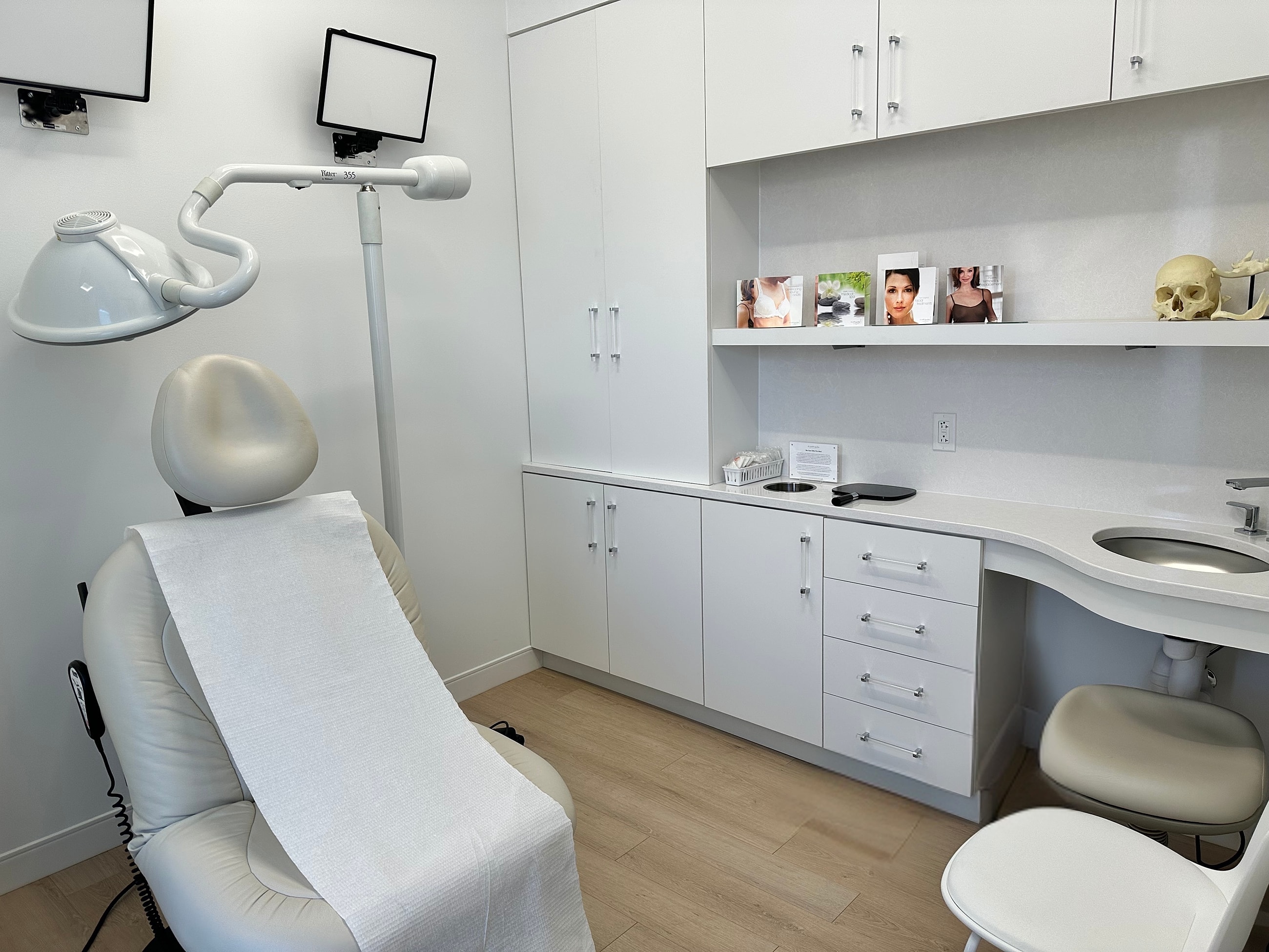 Modern medical office with treatment chair and decor.